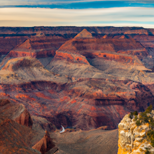 An image capturing the awe-inspiring beauty of the Grand Canyon National Park, showcasing the vibrant hues of towering red rock formations, the vastness of the canyon, and the meandering Colorado River carving through the landscape